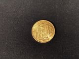 a gold coin with an image of a man and a woman on it