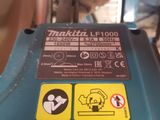 a close up of a blue machine with stickers on it