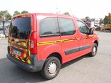 a red van that is parked in a parking lot