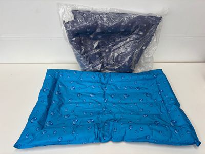 two pieces of blue fabric are sitting on top of a white counter