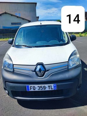 the small white van is parked in a parking lot with a number plate
