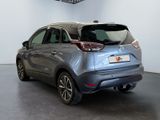 the rear end of a silver car parked in a garage