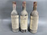 three bottles of wine sitting next to each other on a table