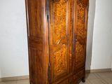 a wooden armoire in the corner of a room