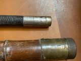 two old baseball bats on a table next to each other