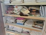 a closet with a lot of clothes on the shelves
