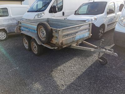 a small trailer with a trailer attached to it