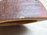 a close up of a piece of rusted metal on a table
