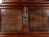 a wooden cabinet with a glass door on top of it