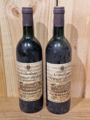 pair of two bottles of wine sitting on a wooden shelf
