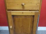 an image of a small wooden cabinet with a drawer