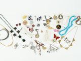 many different types of jewelry on a white surface