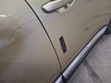 a close up of a car door handle with a sticker on it