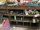 a wooden workbench with lots of tools on top of it