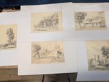 several drawings of a house and trees are shown on a table