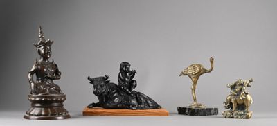 three statues of animals and a bird on a table