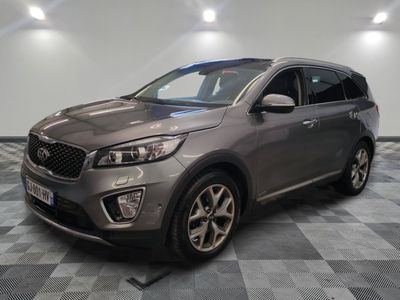 a grey suv parked in a garage with a checkered floor