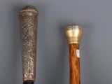 two baseball bats that are sitting next to each other