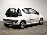 a small white car that is parked in a garage