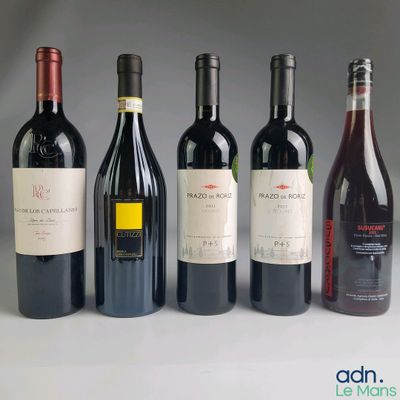 several bottles of wine are lined up in a row on a table