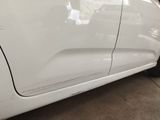 a close up of a white car with the door handle missing