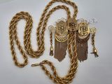 une image représentant une chaîne en or ornée d'une montre et de pompons