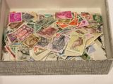 a box full of postage stamps sitting on a table