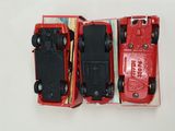 two red toy cars that are sitting in a box