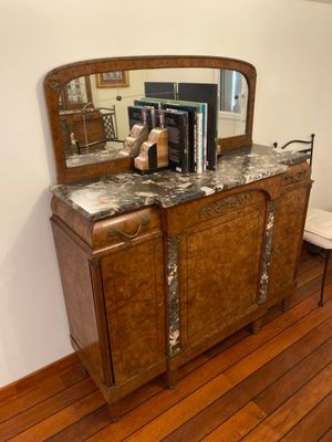 a wooden cabinet with a mirror on top of it