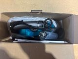 a box with a pair of shoes and a pair of scissors in it