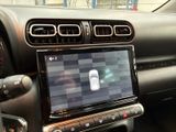 a car dashboard with a cell phone in the center of it
