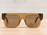 a close up of a pair of sunglasses on a wooden table