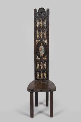 an old wooden chair with a carved back and seat on a white background