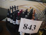 bottles of wine on a table with a price sign in front of them