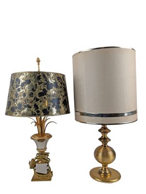 pair of gold and silver lamps with shades on each of them