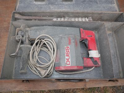 a tool in a metal box on a wooden table