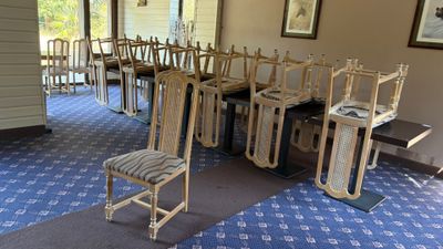 a room with a bunch of chairs and a table in it