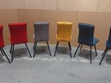 four colorful chairs are lined up in a row in a room
