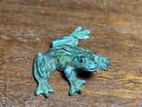 a small frog that is sitting on a table