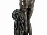 statue of a man and a woman standing on a pedestal