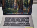 a laptop computer sitting on a desk with a sticky note attached to it