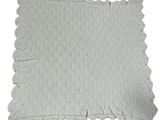 the white blanket has a lacy design on it