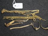a lot of gold chains and bracelets on a table