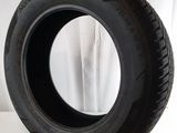 tire on a white surface with a white curtain in the background