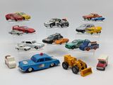 many toy cars in a display case on a white surface