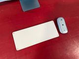a mouse, keyboard, and mouse pad on a red table