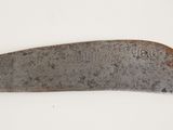 a close up of a knife on a white surface