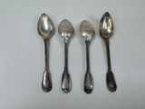 four spoons are lined up in a row on a white surface