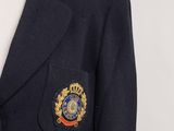 a black jacket with a blue lapel and a badge on the lapel
