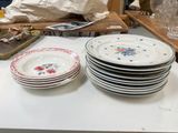 many plates and glasses on a table in a room